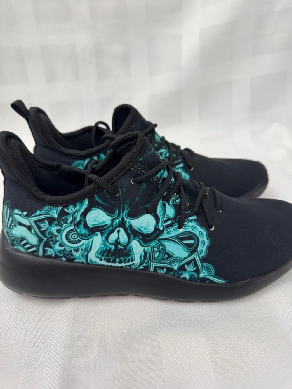 Unisex Black Lightweight Sneakers with Teal Skull Accent